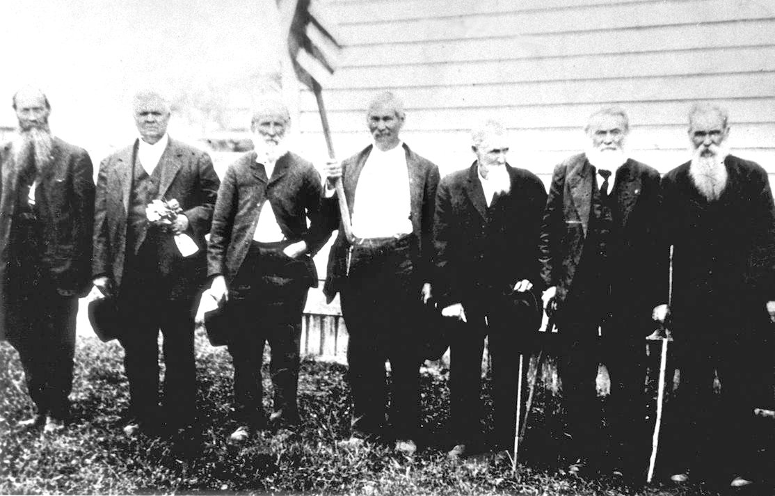 Submitted by Ray Landes
This early 1920s photo shows veterans of the Civil War. Taken in Mossyrock, from left to right, the men are William Young, Si MacFadden, Robert Daniel Silva, Dan Shaner, Robert Amaziah Sparks, Tom Landes and Andrew Jackson Kiser. Silva fought for the South and was in the Battle of Bull Run. Kiser fought for the North with Gen. W.T. Sherman. Both men moved to Ajlune sometime after the war where they became neighbors and friends. From 1893 to 1895, William Young served as the county commissioner from East Lewis County. He had a reputation of holding out for things that would benefit East County residents. Behind his back, William was known by some of the young folk of Mossyrock as “Billy Whiskers,” because, while driving his Dodge with its top down, his whiskers would divide on each side of his face. We also see Charles Thomas Landes in this photo. Thomas came west and established a homestead on the east side of Mossyrock. He moved west after his father, a storekeeper, was shot and killed. Between having survived the brutal Civil War, and losing his father, Tom had wanted to start anew — which is what he did. After moving to this area, Tom became a farmer and logger.